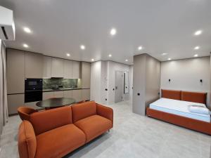 a living room with a couch and a bed at ApartReserve Avtorskiy Aparthotel in Ivano-Frankivsk