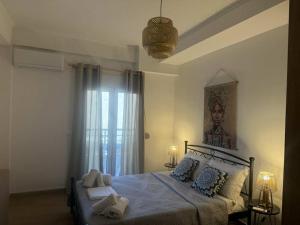 a bedroom with a bed with blue sheets and pillows at Kalisti Apartment in Lixouri