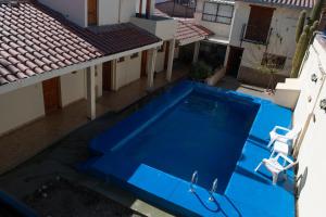 an overhead view of a blue swimming pool on a house at Hotel Cafayate in Cafayate