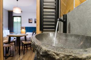 a bathroom with a bath tub and a table with chairs at Willa Jodełka in Zakopane +145 photos