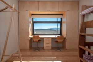 a room with two chairs and a window at Swiss Agricultural School Caucasus in Sarkinetʼi