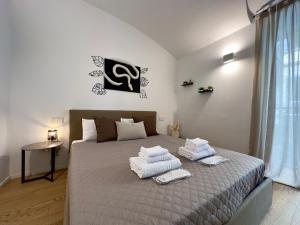 a bedroom with a bed with towels on it at Alfieri 7 Luxury Suite - Centro Torino in Turin