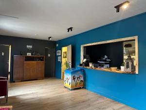 a room with a blue wall and a counter with a box at Hotel Studlagil in Skjöldólfsstaðir