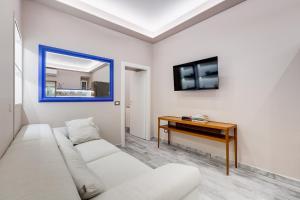 a living room with a white couch and a table at LuxurySistersHouse 2 min Colosseum in Rome