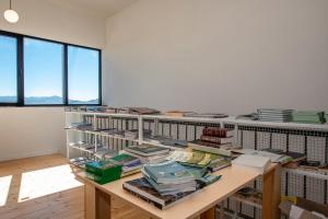 a room with a table with books on it at Swiss Agricultural School Caucasus in Sarkinetʼi