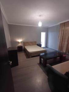 a room with a bed and a table in it at Шода in Gari