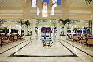 a lobby of a resort with a table and chairs at Bahia Principe Grand Aquamarine - Adults Only All Inclusive in Punta Cana