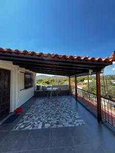 a patio with a table and chairs on a roof at Blue Olive House & Studio in Artemida
