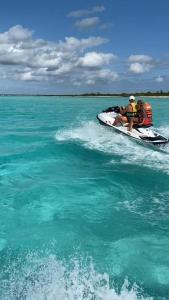 two people on a jet ski in the water at Portal Mar Pousada in Maragogi