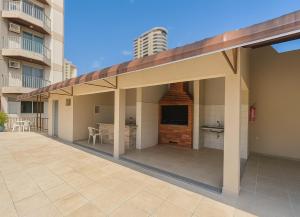 a large outdoor patio with a television and a building at COP30 Apartment In The Center in Belém