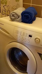 a washing machine with towels on top of it at Ventspils Juras in Ventspils