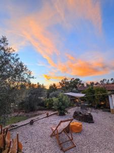a patio with a table and chairs under a cloudy sky at Riverlake House - frente ao lago e com jardim in Vila de Rei +15 photos