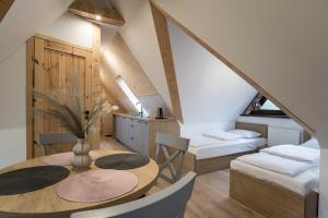a dining room with a table and chairs in a attic at Willa Jodełka in Zakopane