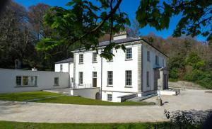 a large white house with a driveway at Marble Hill House in Marble Hill
