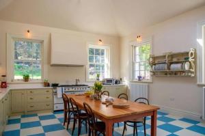 a kitchen with a wooden table and chairs in it at Marble Hill House in Marble Hill