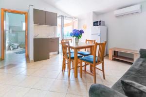 a kitchen and dining room with a table and chairs at Apartment Vir Croatia in Vir