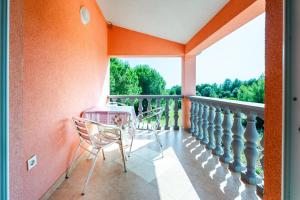 a balcony with a table and chairs on it at Apartment Vir Croatia in Vir