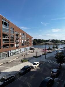 a parking lot with cars parked in front of a building at Great two bedrooms apartment with a sea view from the balcony close Helsinki center in Helsinki