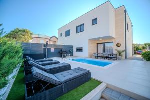 a backyard with a swimming pool and a house at New - Luxury Villa Angel - private pool in Vir