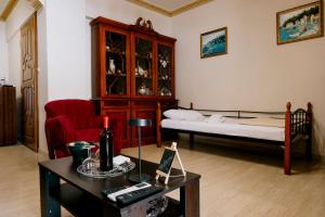 a living room with a bed and a table at Sq Varnava apartment Athens in Athens