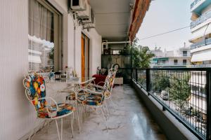 a balcony with a table and chairs on it at Sq Varnava apartment Athens in Athens