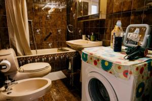 a bathroom with a toilet and a sink and a washing machine at Sq Varnava apartment Athens in Athens +43 photos