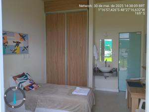 a bedroom with a bed and a sink in it at KAA Flat in Belém