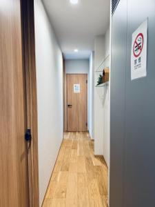 a hallway with a wooden door and a hallway sidx sidx sidx at Akikawa Villas 13 - Vacation STAY 18846 in Fukumoto
