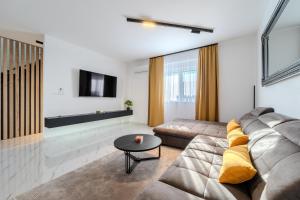 a living room with a couch and a tv at New - Luxury Villa Angel - private pool in Vir