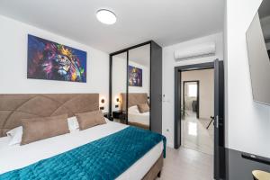 a bedroom with a king sized bed and a television at New - Luxury Villa Angel - private pool in Vir +45 photos