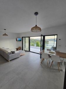 a living room with a table and a couch at Moon Lake Bicaz - Aurora Sky in Buhalniţa