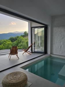 a house with a swimming pool with a view at Moon Lake Bicaz - Aurora Sky in Buhalniţa