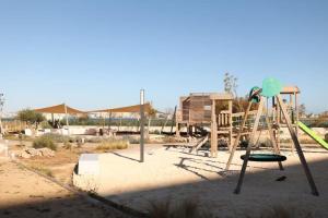 an empty playground with a swing set in a park at Casa Sueno Dream in Playa Honda