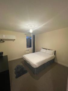 a bedroom with a white bed and a window at 2 Bedroom by JL Airport & Retail in Liverpool