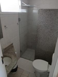 a bathroom with a shower with a toilet and a sink at Pousada America do Sol in Natal +45 photos