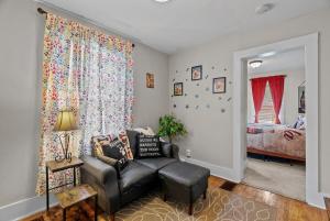a living room with a couch and a bedroom at Coca Cola Cottage - Stay & Play Near Purina Farms - Dog Friendly in Pacific