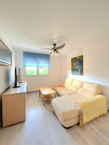a living room with a couch and a table at Huerta Nueva Suites in Estepona