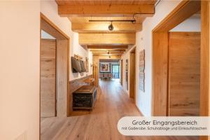 a hallway of a house with wooden walls and wooden floors at INVITA Natur-Chalets Penthouse - Familienurlaub im Schwarzwald - 240qm in Bad Dürrheim