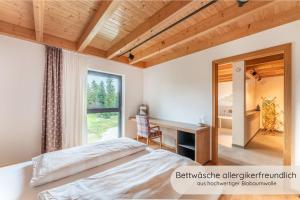 a bedroom with a bed and a desk and a window at INVITA Natur-Chalets Penthouse - Familienurlaub im Schwarzwald - 240qm in Bad Dürrheim +50 photos