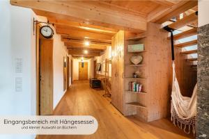 a hallway in a house with a clock on the wall at INVITA Natur-Chalets Penthouse - Familienurlaub im Schwarzwald - 240qm in Bad Dürrheim