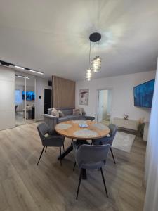 a living room with a table and chairs and a couch at Vestiq ARAD in Arad