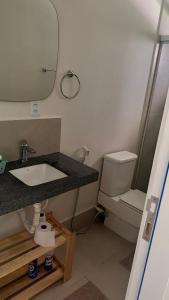 a bathroom with a sink and a toilet at Boa Vista Suítes in Água Boa
