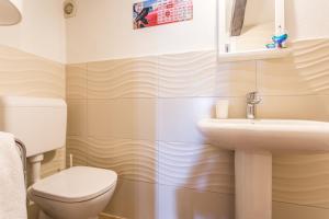 a bathroom with a toilet and a sink at Apartment Memories II in Baška