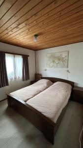 a large bed in a bedroom with a wooden ceiling at Le Belle Homme in Gouvy +44 photos