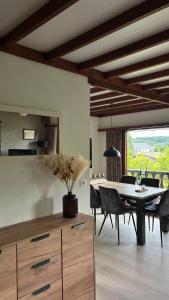 a kitchen and dining room with a table and chairs at Le Belle Homme in Gouvy