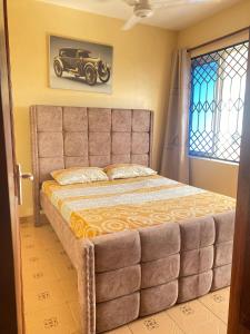 a bedroom with a large bed with a car on the wall at SuNRISE LUXURY HOMES in Mtwapa