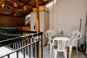 a balcony with a table and white chairs at Sq Varnava apartment Athens in Athens