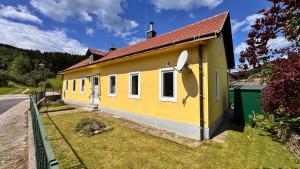 a yellow house on the side of a road at Das Markt 28 - Urlaub wie zu Hause in Kirchberg am Wechsel