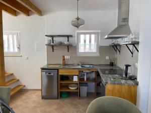 a kitchen with a sink and a counter top at Almada Negreiros in Vila Nova de Milfontes