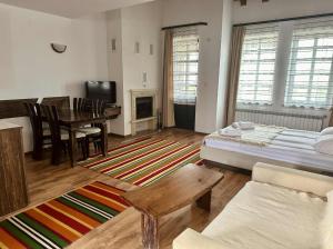 a living room with a bed and a table at Студио in Starosel